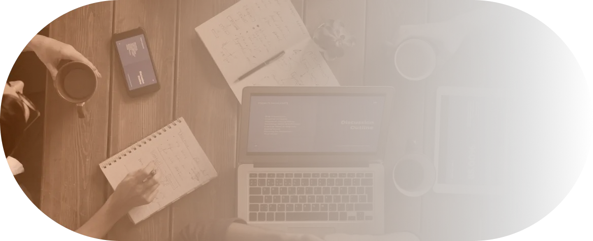 A desk with a laptop and design materials